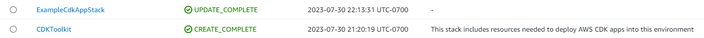 CloudFormation stack showing ExampleCdkAppStack update complete and CDKToolkit creation complete.