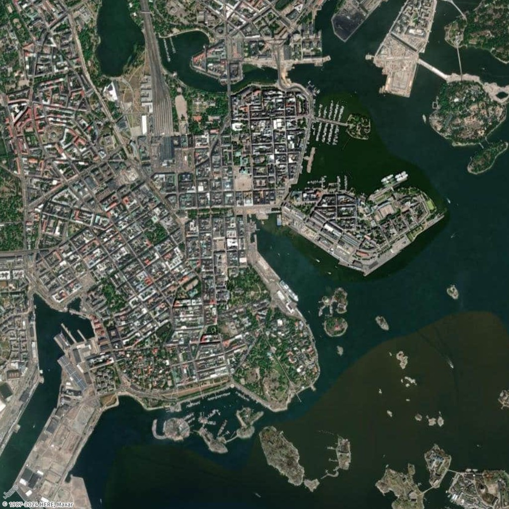 Aerial view of a coastal city with dense urban areas, harbors, and small islands.