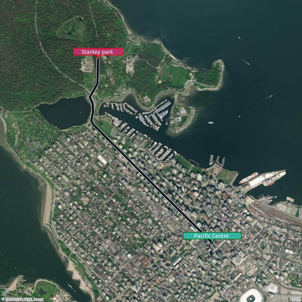 Aerial view of Vancouver with Stanley Park and Pacific Centre marked, showing urban layout and coastline.