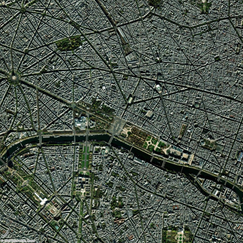 Aerial view of Paris showing dense urban layout, Seine River, and iconic landmarks.