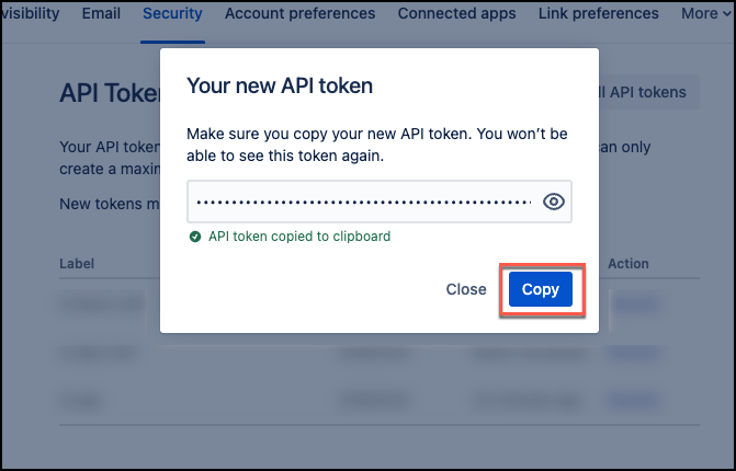 Screenshot of the "Your new API token" dialog box displaying the generated API token that needs to be copied and saved.
