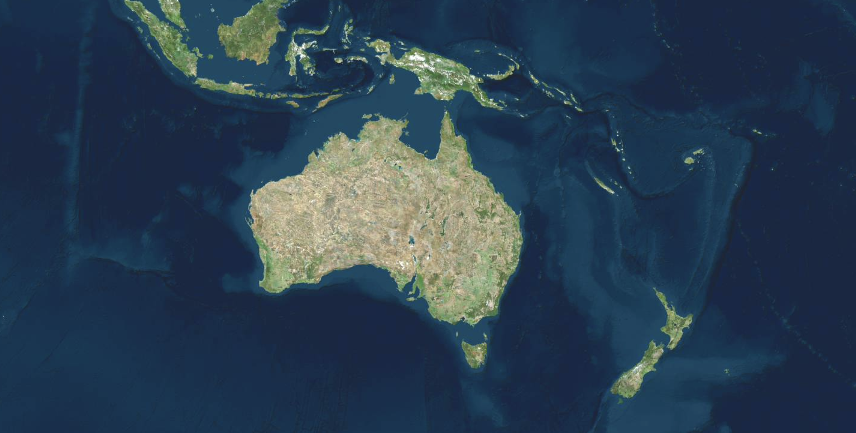 Satellite view of Australia, New Zealand, and Southeast Asian islands surrounded by deep blue oceans.