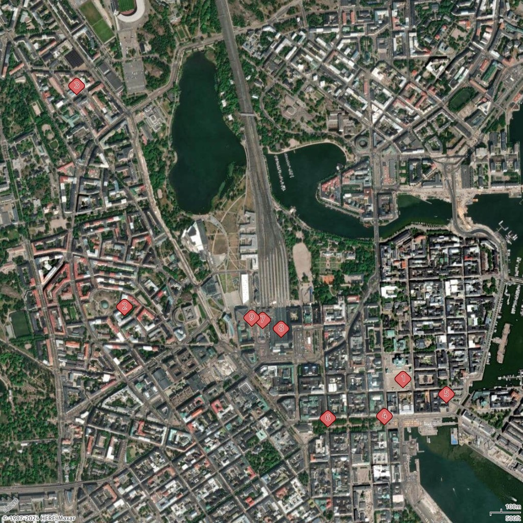 Aerial view of a city with lakes, buildings, roads, and numbered markers indicating points of interest.